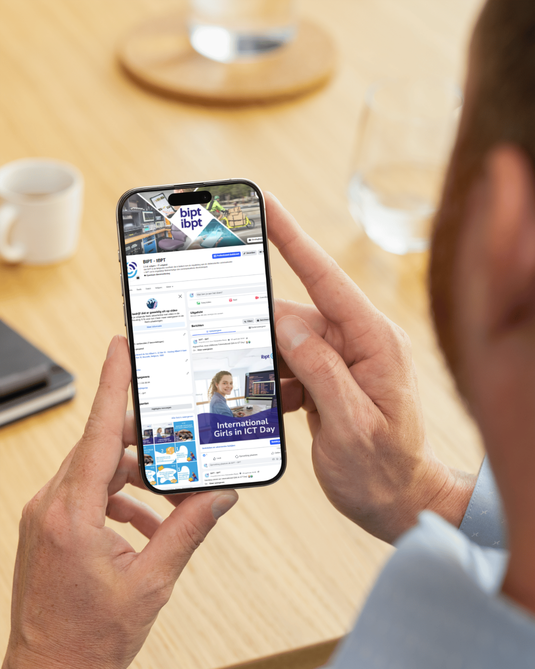 Foto van iemand die op zijn smartphone een van de websites van het BIPT bekijkt